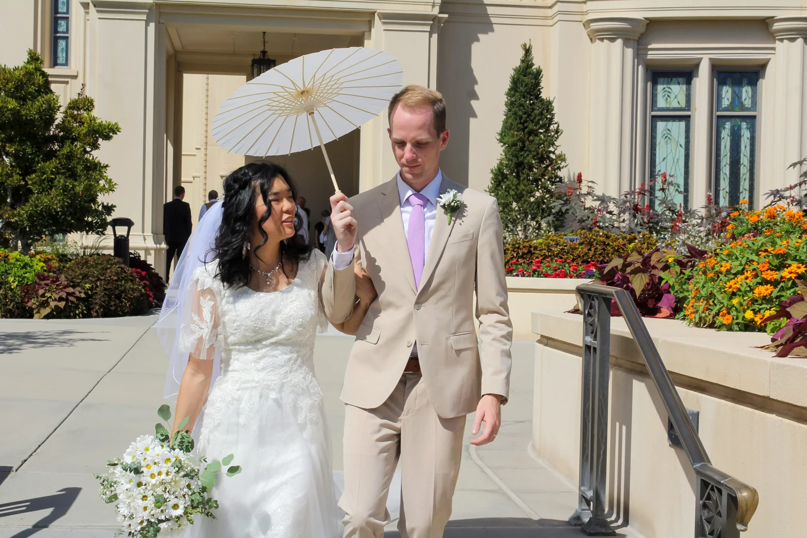 Newly married couple walking together outside the temple