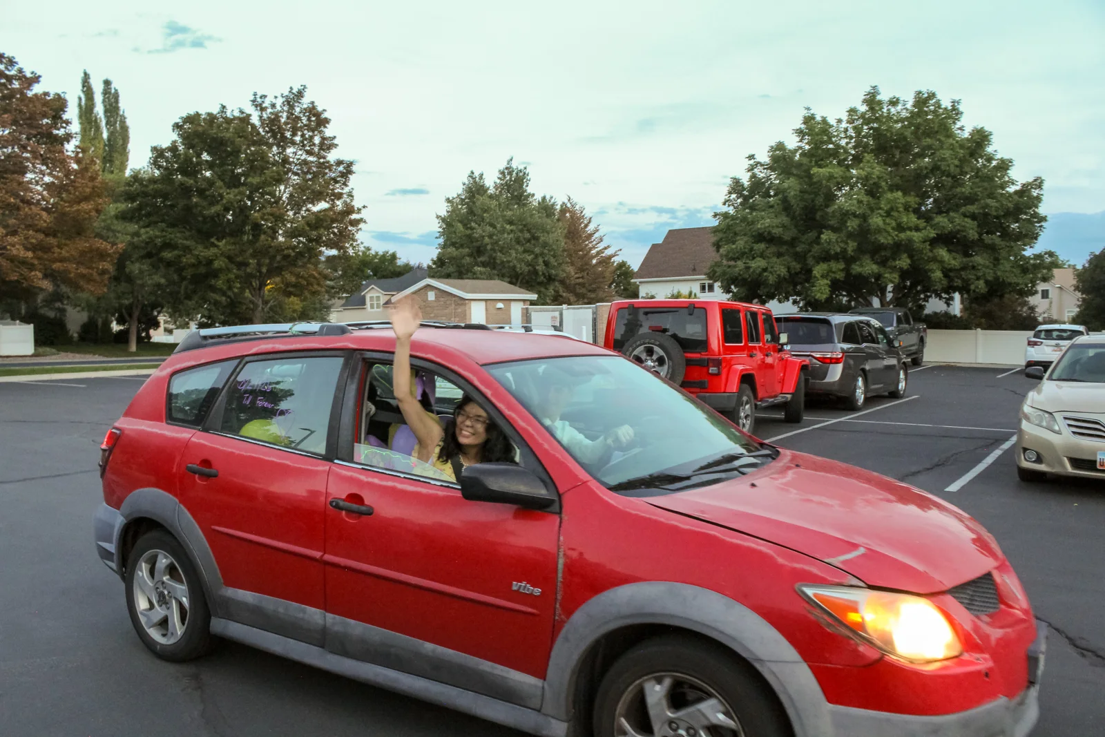 Wedding send-off in a decorated red car